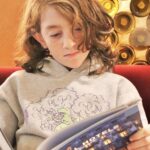 boy child reading by himself