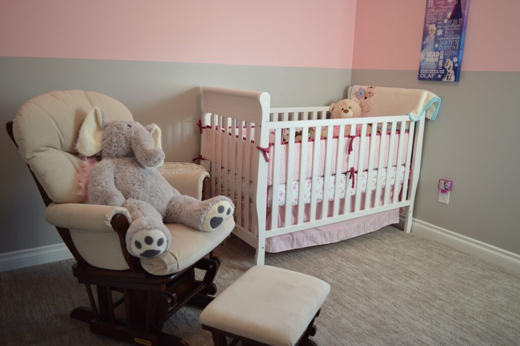 baby nursery with stuffed elephant and crib. Image by Erika Wittlieb from Pixabay