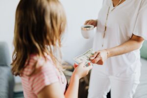 Mother handing child money